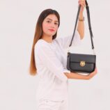 black-saddle-bag-with-twist-lock-model-closeup.jpg